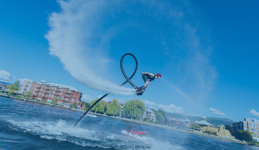 Flyboard rider rising above the water on a jet of spray