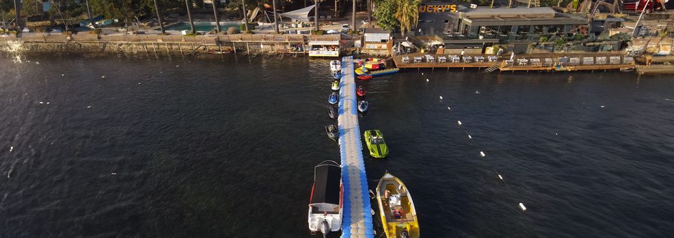 Aerial view of the Nova Watersports pier with jet skis, a jetcar and boats